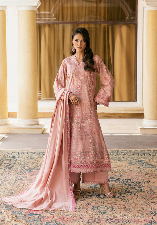 Woman in a pink traditional outfit standing in an elegant indoor setting with columns and a patterned rug in ELAF LUXURY WINTER