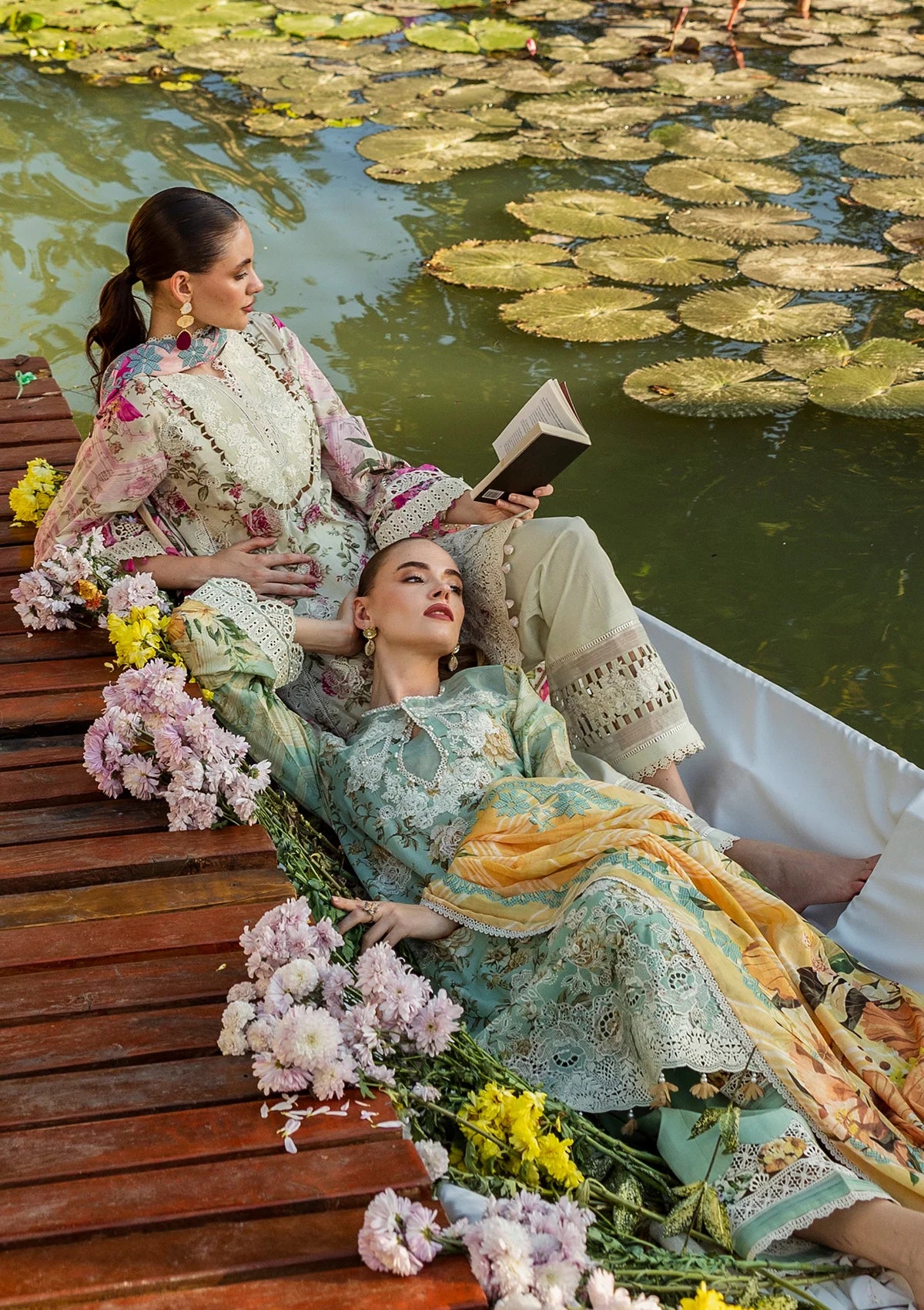 wearing elegant lawn dresses with vibrant prints.