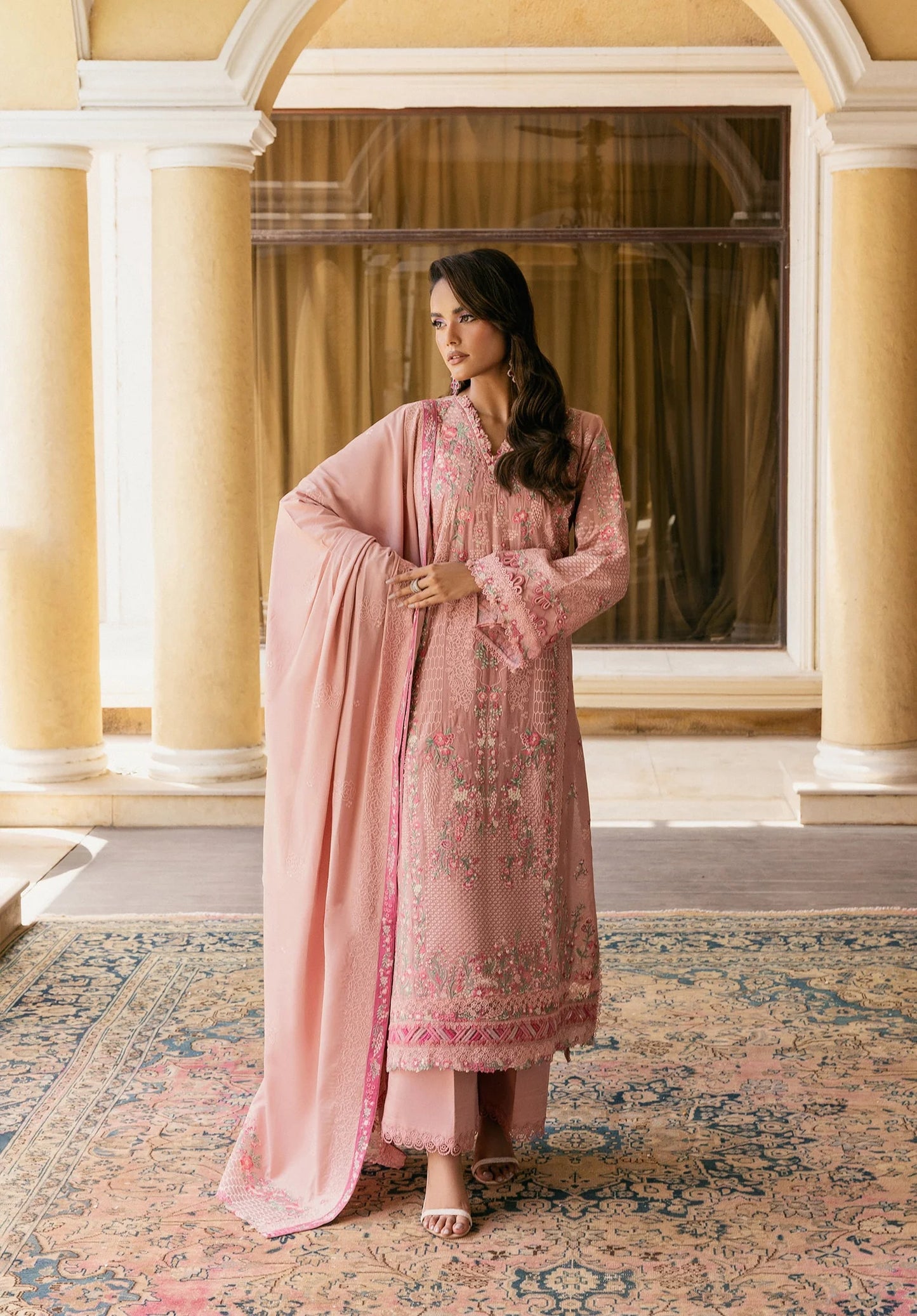 Woman in a pink traditional outfit standing in a room with ELAF LUXURY WINTER