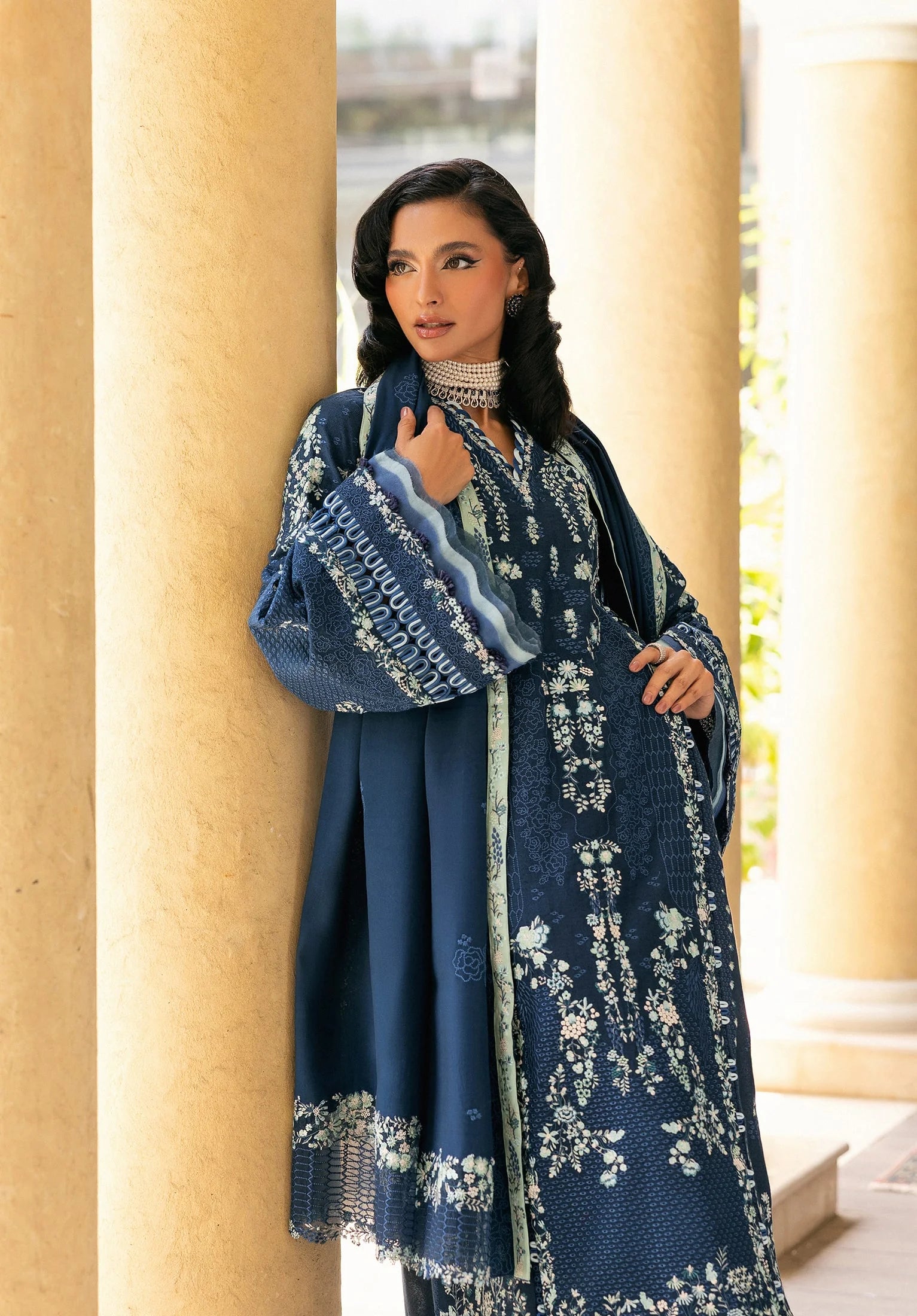 Woman wearing a blue embroidered dress from elaf LUXURY WINTER '25.